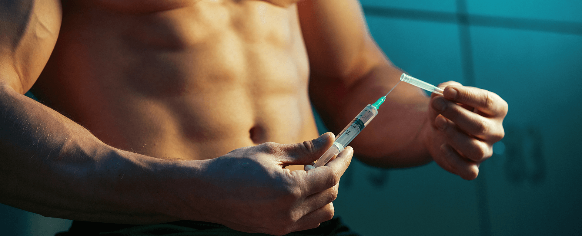 Muscular Man Holding Syringe - Difference Between Steroids and Injectable HGH